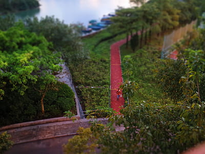 Person in Red Shirt Walking on Red Pavement thumbnail