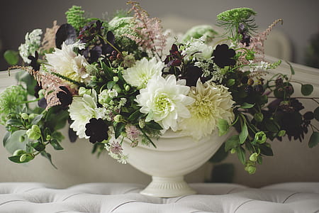 white petaled flower centerpiece on tufted gray fabric pad thumbnail