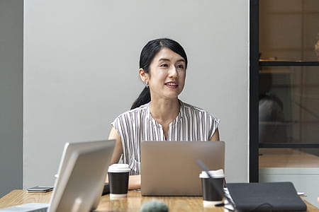 woman sitting on chair in front of laptop above table thumbnail