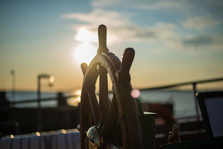selective focus photo of brown wooden ship steering wheel thumbnail