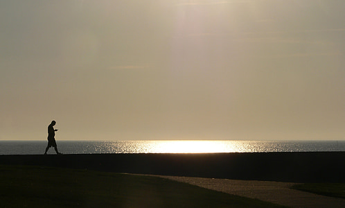 man walking near shore thumbnail