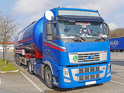 blue tanker truck parked on road side thumbnail