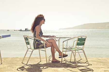 Woman Sitting on Armchair Near Seat thumbnail