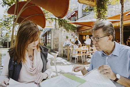 man in blue polo shirt seating in front of woman thumbnail