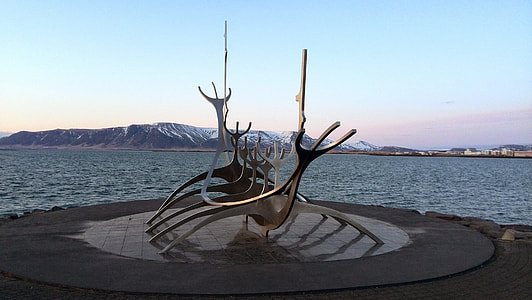 gray boat statue near body of water under blue sky at daytime thumbnail
