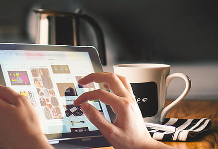 Browsing and shopping on a mobile tablet while enjoying morning coffee. thumbnail