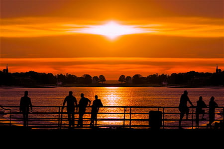 silhouette of people standing beside handrail thumbnail
