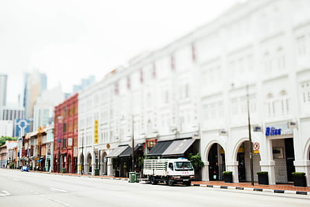 white truck parked beside building thumbnail
