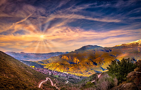 mountains under gray clouds during sunset thumbnail