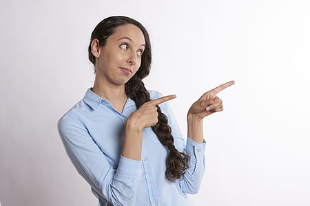 woman pointing her two index fingers on right side thumbnail