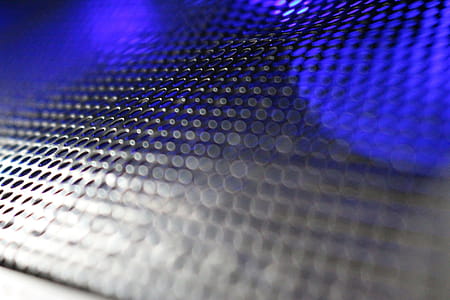Abstract background of metallic mesh with blue and white light shining through thumbnail