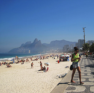 woman walking near seashore during daytime thumbnail
