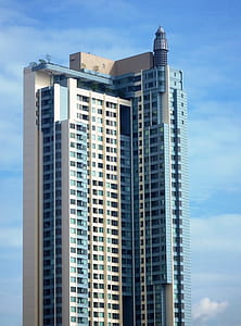 Generic high-rise condominium building against a blue sky background - Editorial use only thumbnail