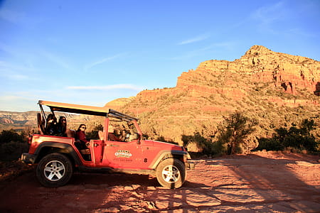 Red All-terrain Vehicle on Brown Rock Field during Sunset thumbnail