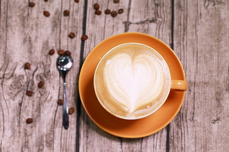 orange ceramic mug on saucer thumbnail
