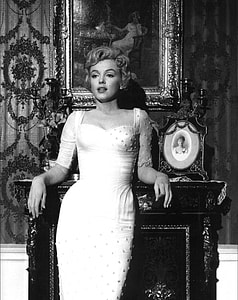 Marilyn Monroe leaning on fireplace mantel thumbnail