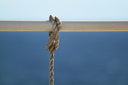 brown rope tied on white metal bar during daytime thumbnail