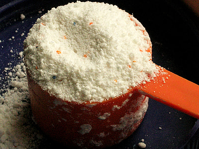 white powder in red plastic measuring cup thumbnail