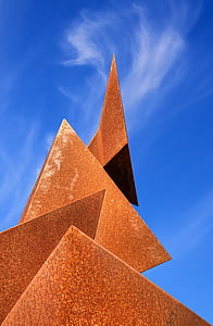 low-angle photo of triangle shaped under cloudy blue sky during daytime thumbnail