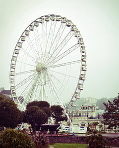white ferris wheel near building thumbnail