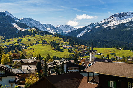 aerial view of buildings near green grass land thumbnail