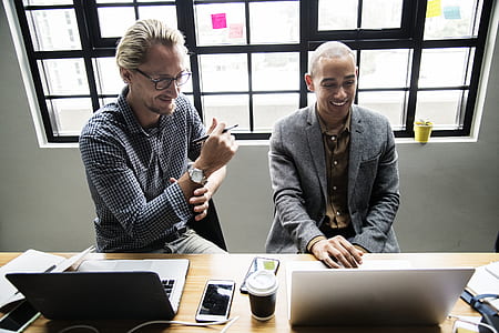 two man sitting in front of a brown wooden table thumbnail
