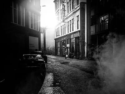 gray scale photography of black car parked near building thumbnail