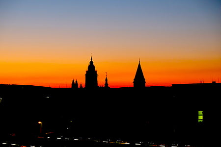 silhouette of two towers during golden hour thumbnail