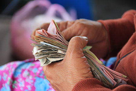 person holding stack of banknote thumbnail