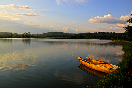 orange row boat over body of water thumbnail