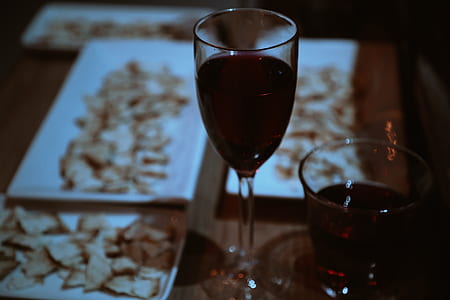 plates of chips beside wine glasses on table thumbnail