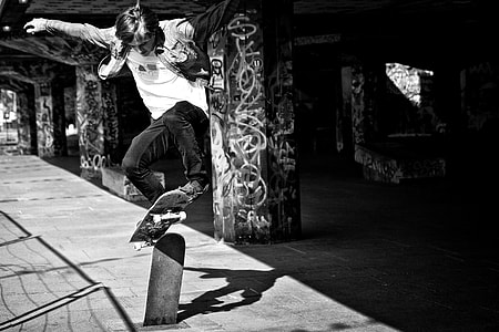 Action shot of a skater doing a jump on the Southbank in London, England thumbnail