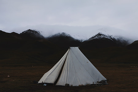white tent near mountain range thumbnail