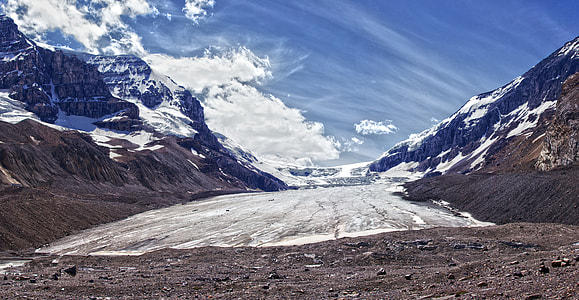 snow mountains under cloudy sky during daytime thumbnail