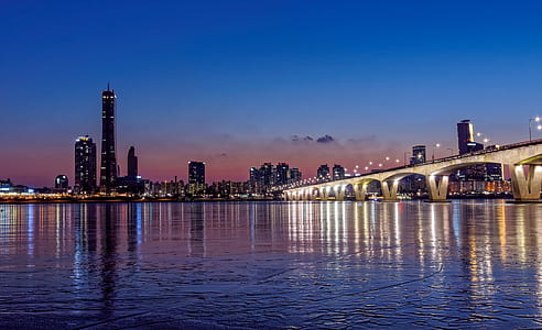 landscape photography of cityscape with concrete bridge thumbnail