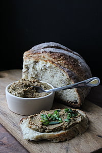 slice breads and round white ceramic bowl on brown wooden board thumbnail