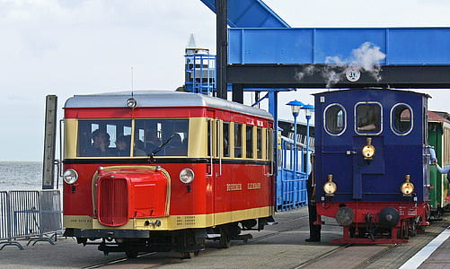 two blue and red trains travelling at daytime thumbnail