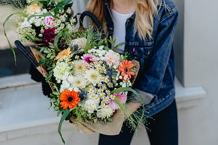 Young woman with basket full of flowers thumbnail