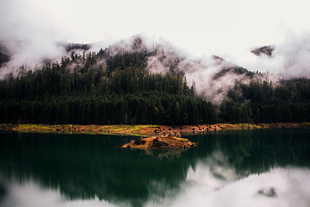 landscape photography of mountain near body of water thumbnail