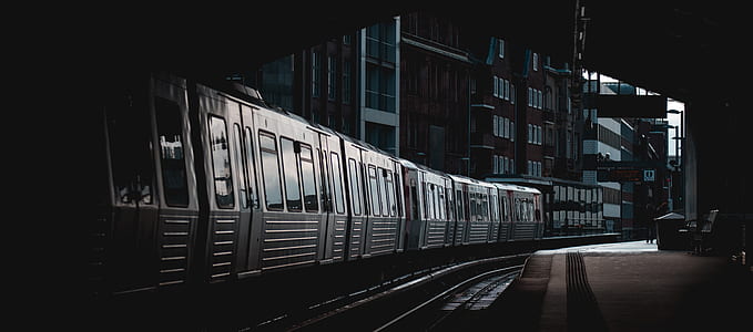 gray metal train near buildings thumbnail
