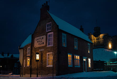 brown and white wooden house at night thumbnail