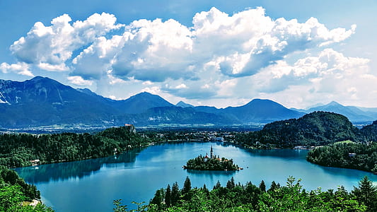body of water, clouds, mountains, and isle during daytime thumbnail