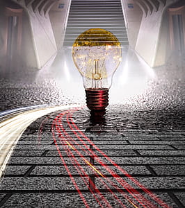 light bulb on grey pavement blocks thumbnail