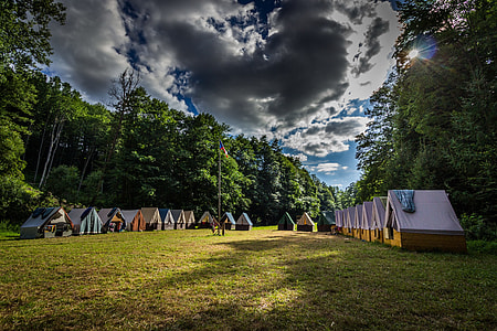 brown camp house surrounded with trees thumbnail