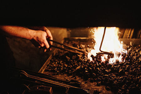 person holding black metal tong near fire thumbnail