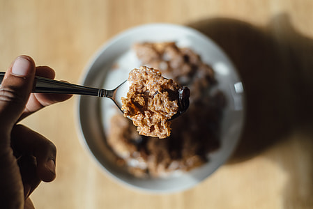 person holding spoon with cereal thumbnail