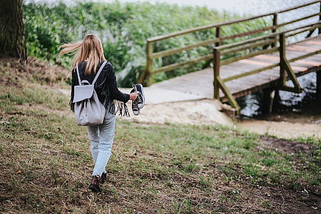 Blonde woman having a healthy snack at the wooden pier thumbnail