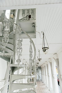 pendant lamps near white spiral stairs thumbnail