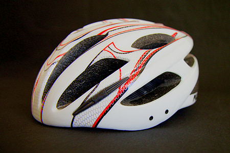 white and orange bike helmet on gray surface thumbnail
