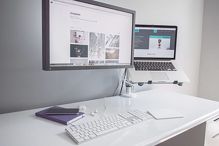 silver MacBook on white wooden desk thumbnail